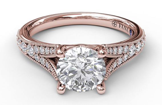 A rose gold split shank diamond side stone engagement ring.