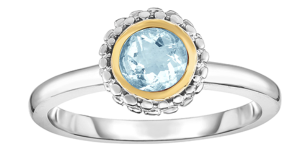 A yellow gold and sterling silver fashion ring with round cut amethyst stone and intricate metalwork surrounding it.