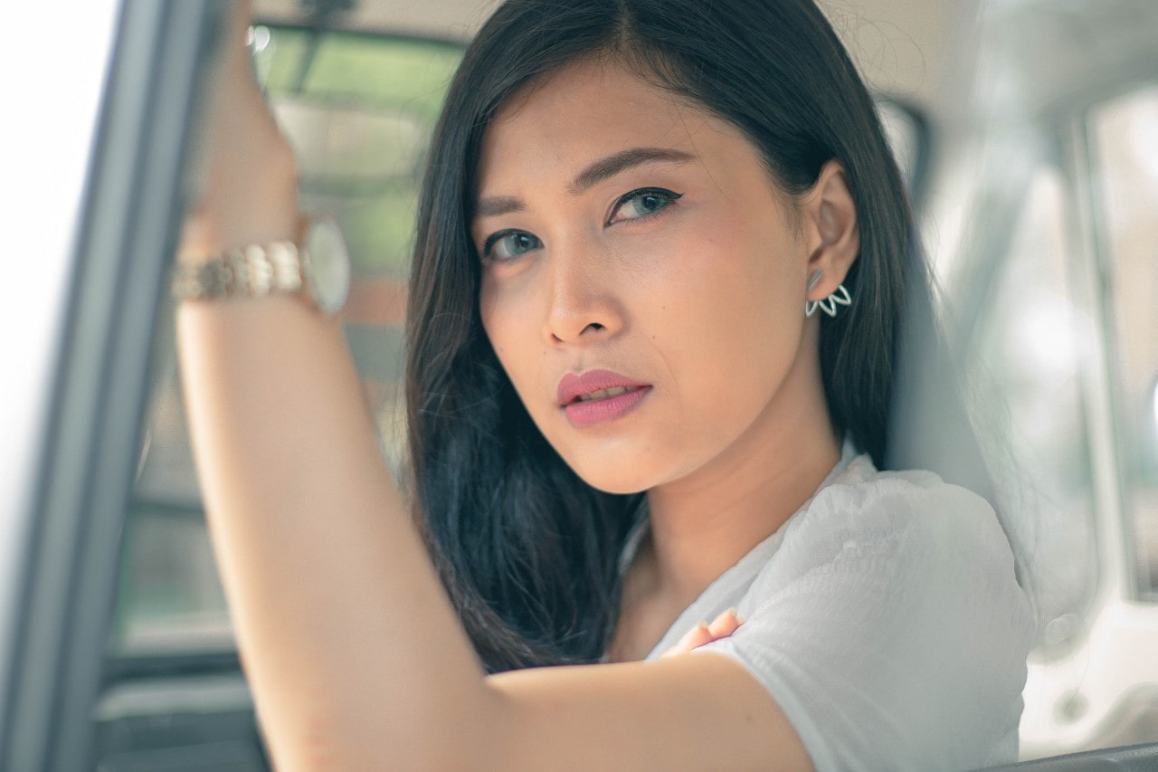 lady sitting in a car and wearing matching jewelry