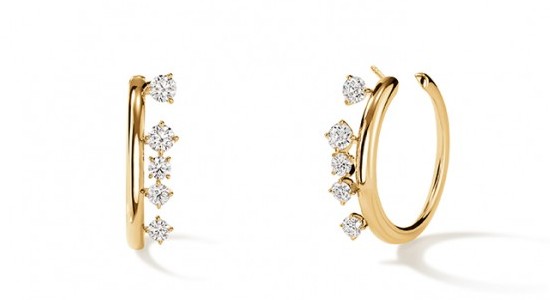 A pair of yellow gold huggie earrings with diamond accents, available at Brockhaus Jewelry.