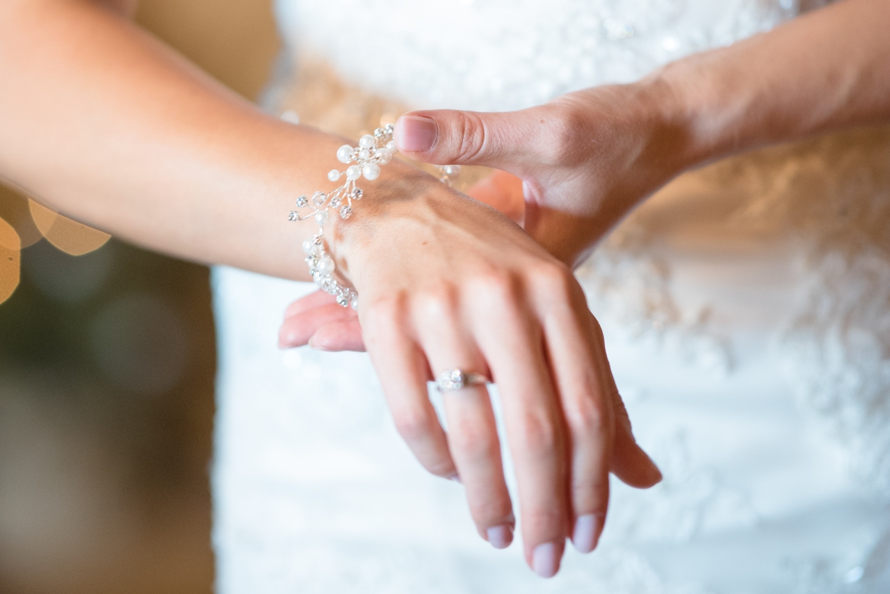 A close-up of a bride’s wrist, adorned with a delicate pearl bracelet.