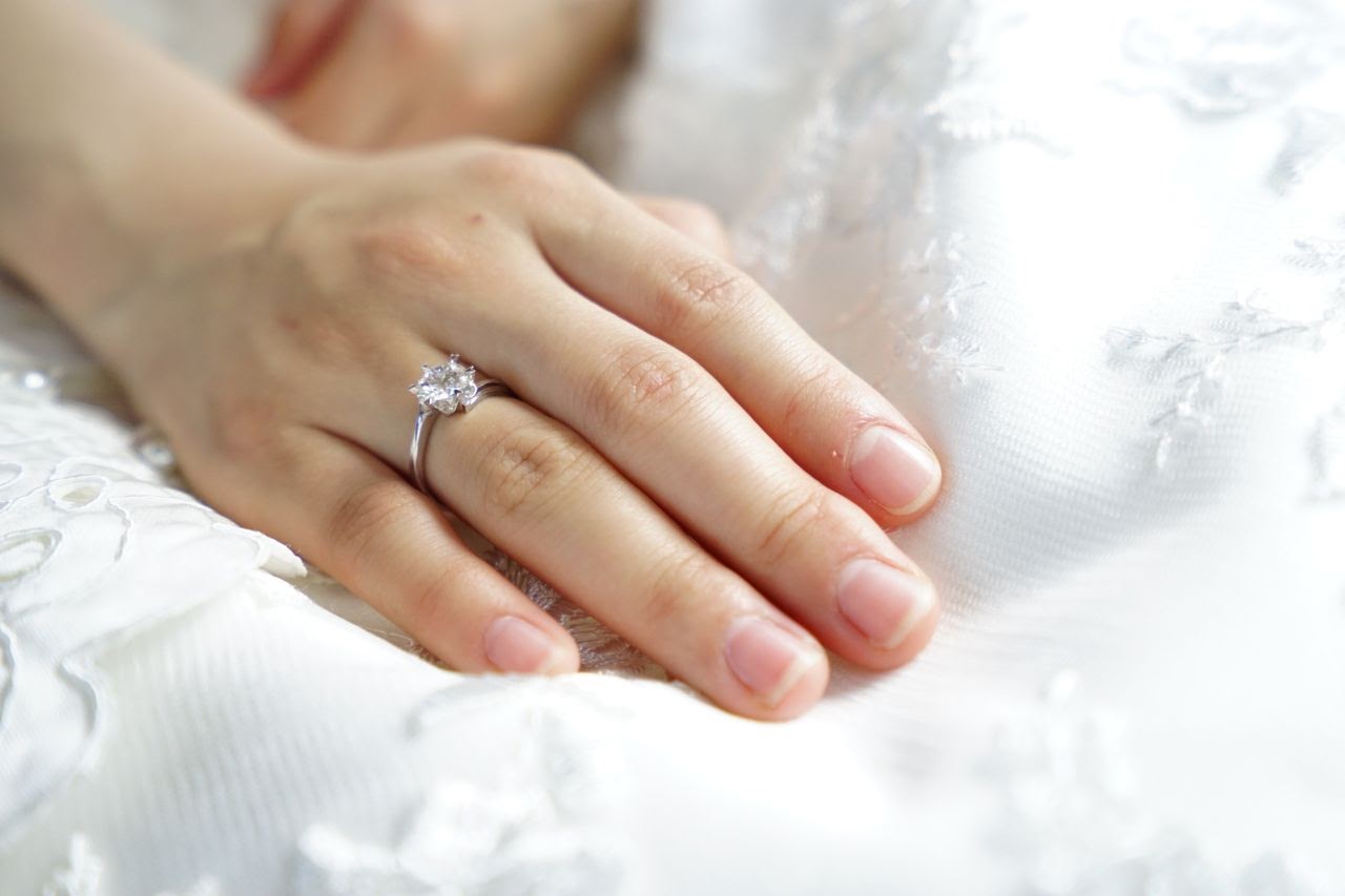 woman with oval cut ring on pillow