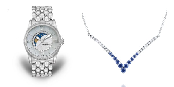 A moonphase watch next to a diamond and sapphire necklace