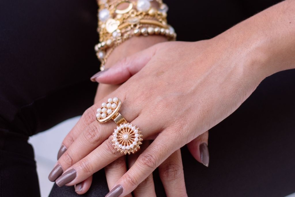Lady wearing a unique pearl fashion ring stack.