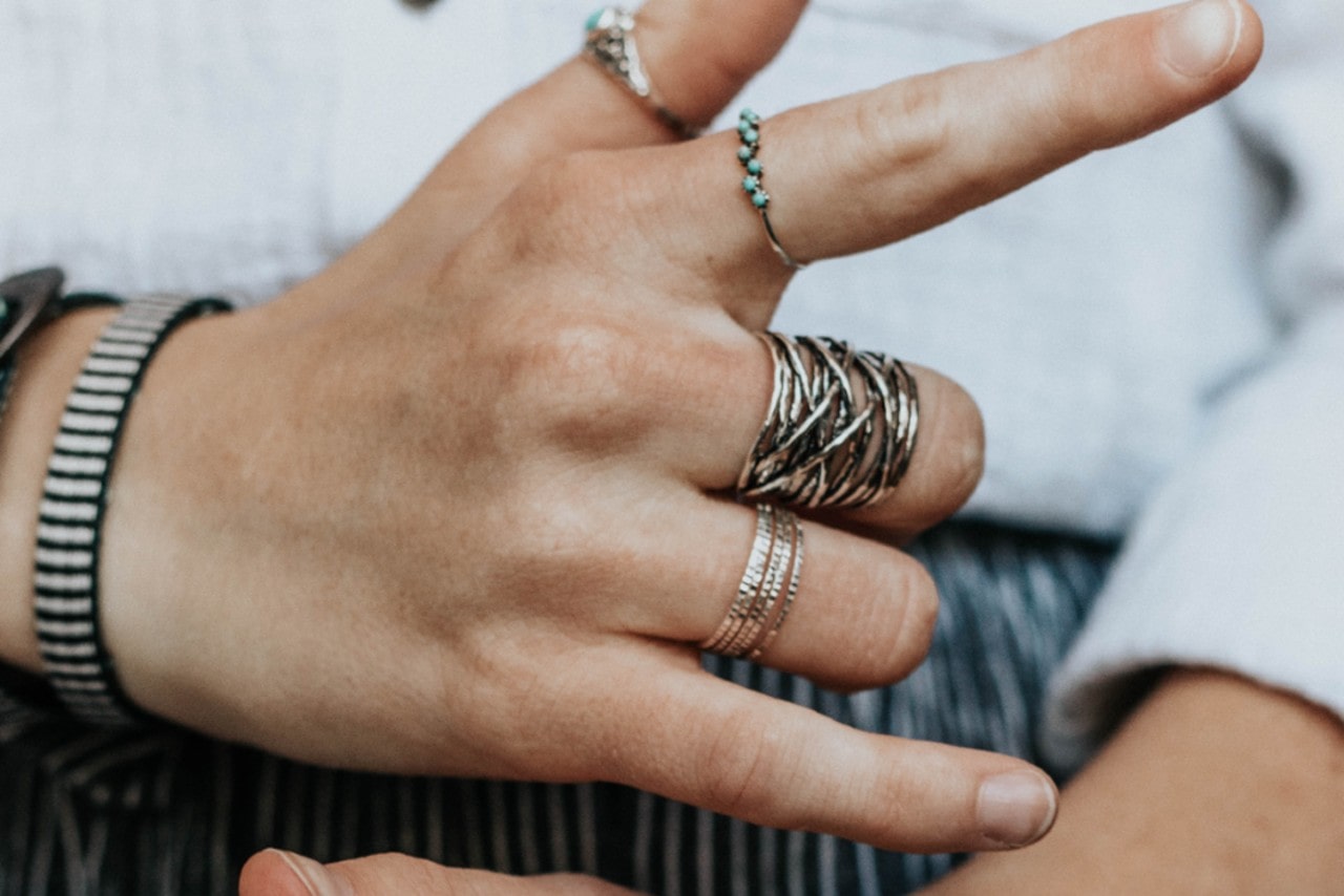 Man wearing multiple sterling silver fashion rings.