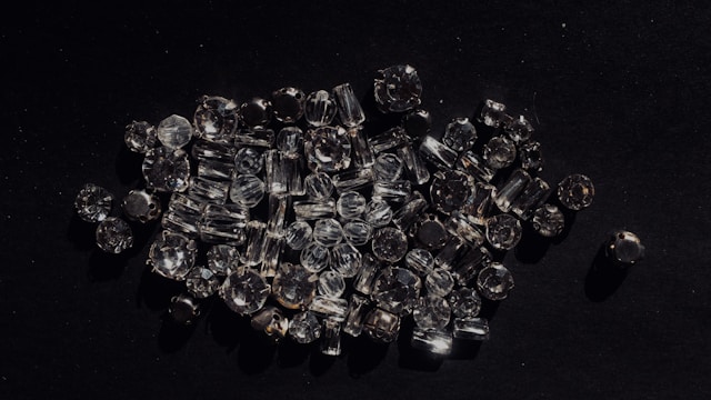 A variety of diamond cuts scattered throughout a dark grey surface.