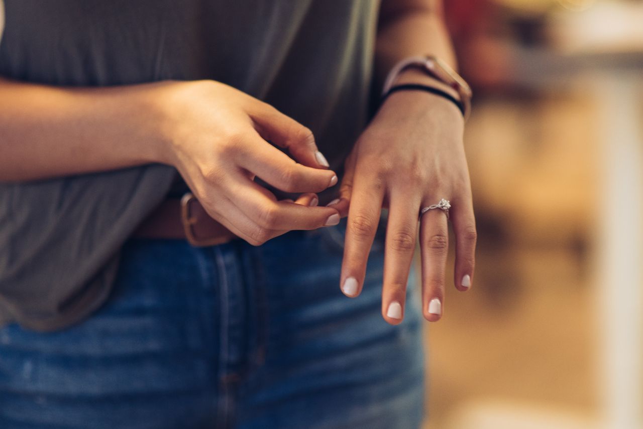 Someone admiring their beautiful, floral engagement ring.