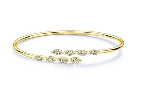A Hearts on Fire diamond bangle crafted in yellow gold.