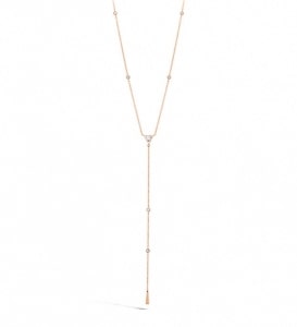 A yellow gold lariat necklace features Hearts On Fire’s signature diamond accents. 