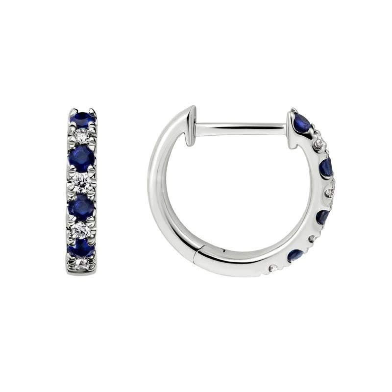 A white gold huggie earrings with sapphires and diamonds on a white background