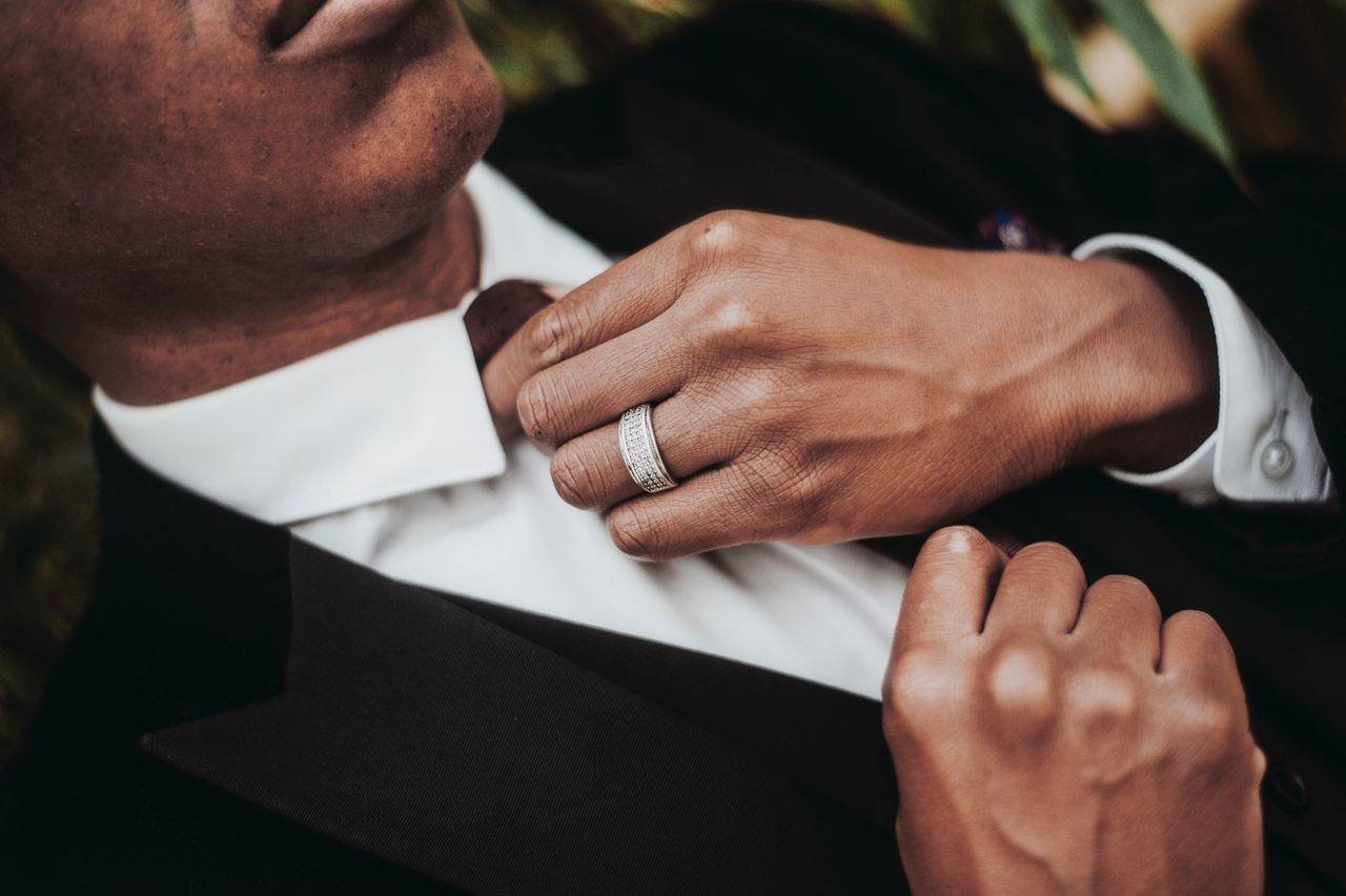 man wearing formal clothes and a wedding band