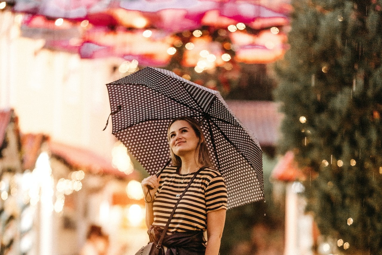 a woman holding umbrella